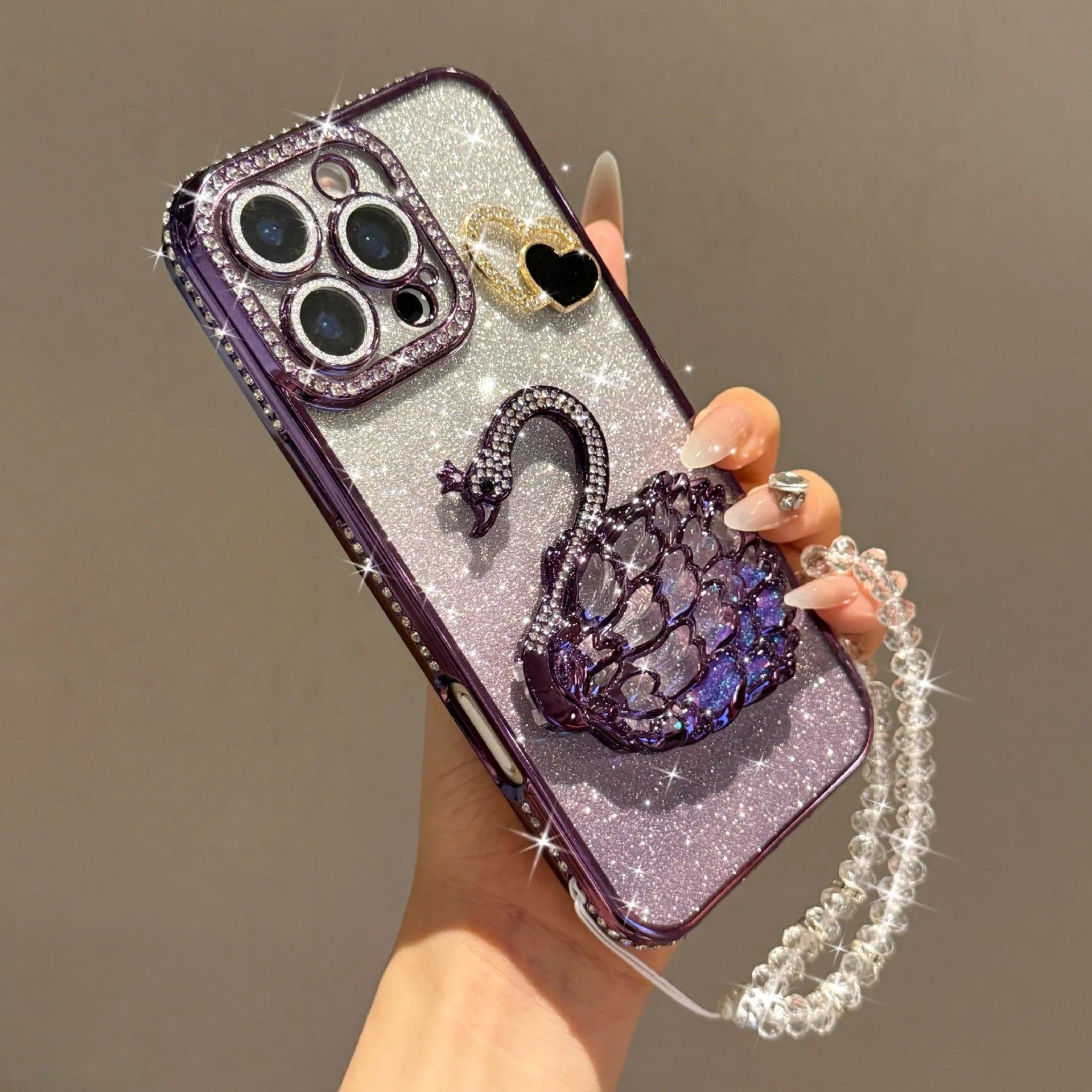 The heart-shaped glitter swan Sand stand is suitable for iPhone17 16 14 13 12 15 11promax phone cases with a pendant